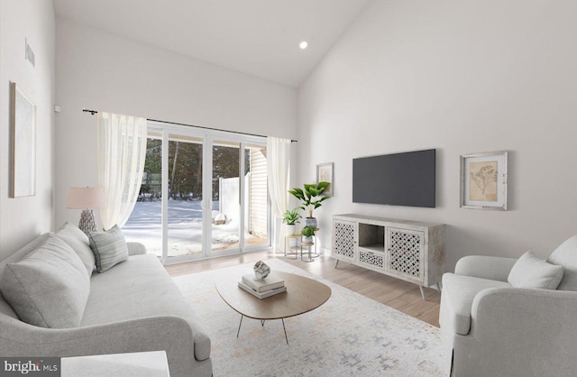 living room featuring light hardwood / wood-style flooring and high vaulted ceiling