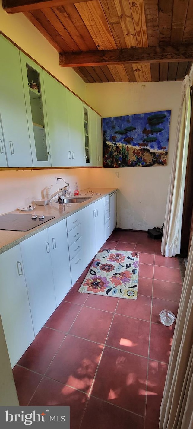 bathroom with tile patterned flooring, wood ceiling, and beam ceiling