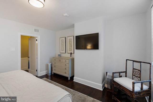 bedroom with dark wood-type flooring