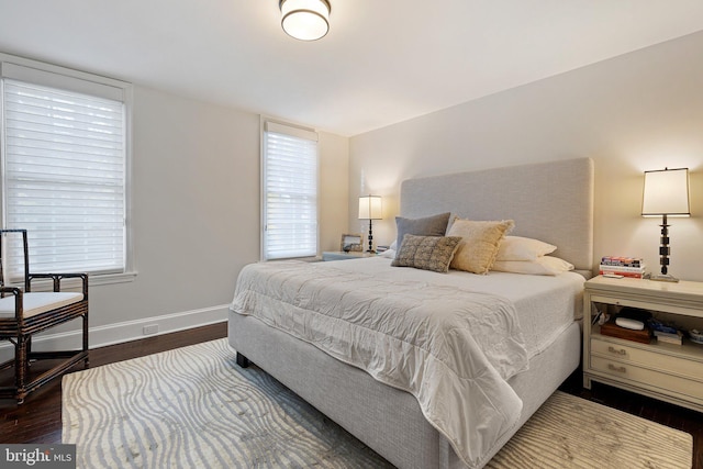 bedroom with dark hardwood / wood-style flooring