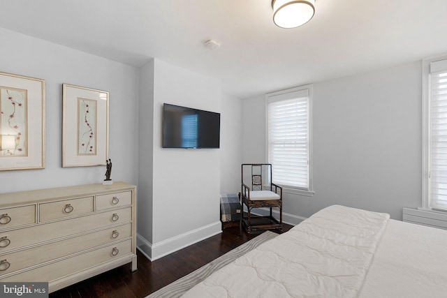 bedroom featuring dark hardwood / wood-style flooring