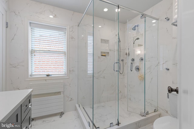 bathroom featuring vanity and a shower with shower door