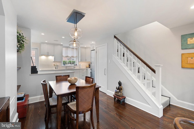 dining space featuring dark wood-type flooring