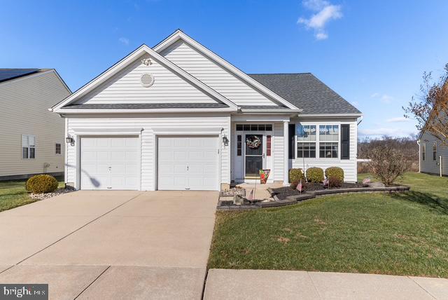 view of front of home with a garage and a front yard