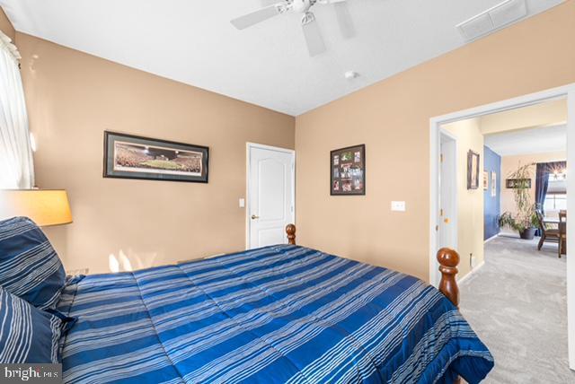 carpeted bedroom featuring ceiling fan