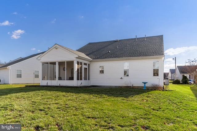 back of house featuring a sunroom and a yard