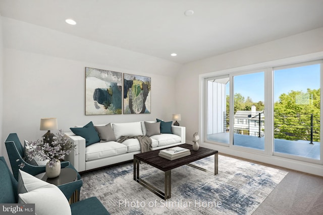 living room featuring carpet floors and lofted ceiling