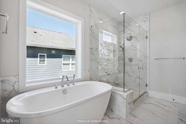 bathroom featuring shower with separate bathtub