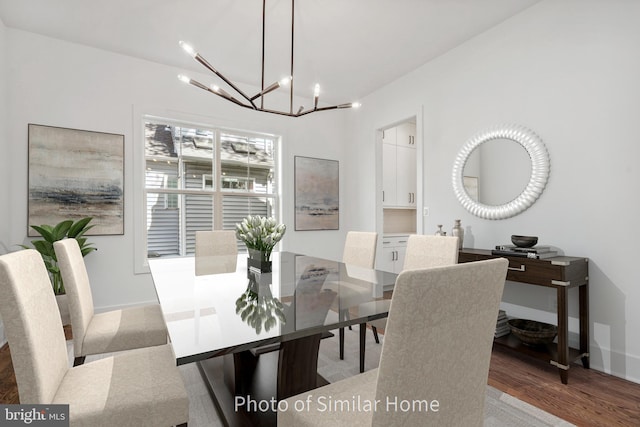 dining area featuring hardwood / wood-style floors and a notable chandelier