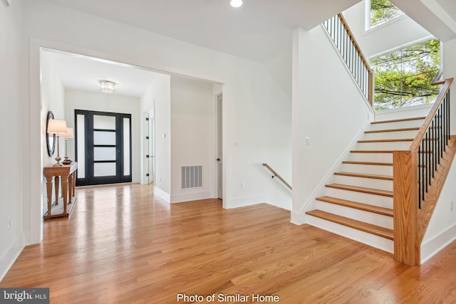 foyer entrance featuring light hardwood / wood-style floors and a wealth of natural light