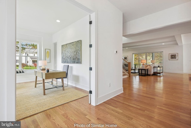 hallway with light hardwood / wood-style flooring