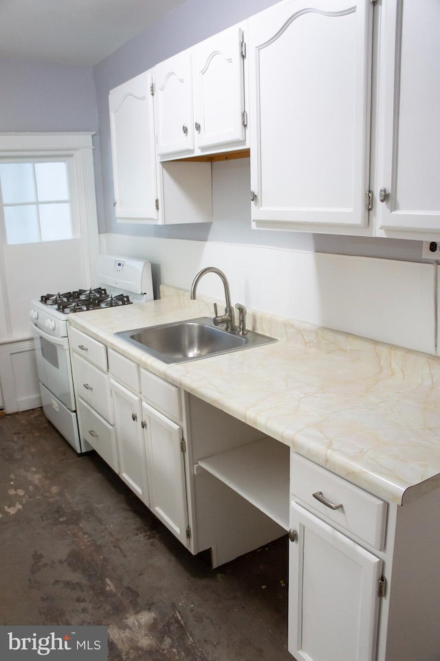 kitchen featuring sink, white cabinets, and white gas range oven