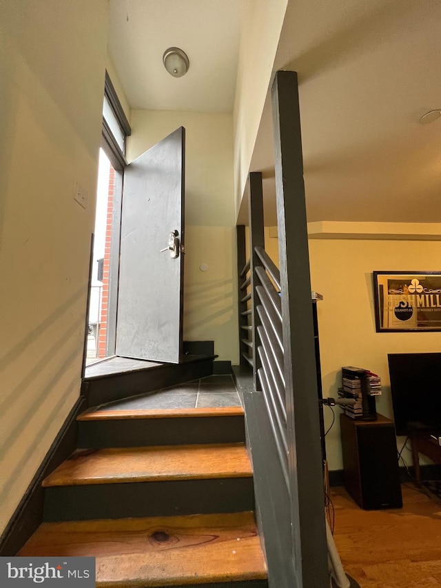 stairway featuring hardwood / wood-style flooring