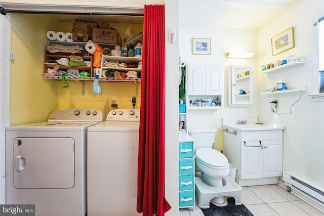 washroom with independent washer and dryer, light tile patterned floors, a baseboard heating unit, and sink