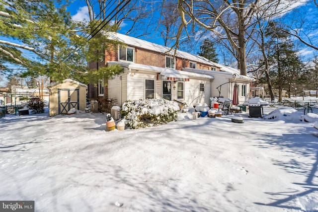 view of front of home featuring a storage unit