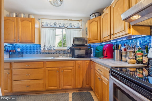 kitchen featuring sink, ventilation hood, stainless steel range with electric stovetop, decorative backsplash, and light tile patterned floors