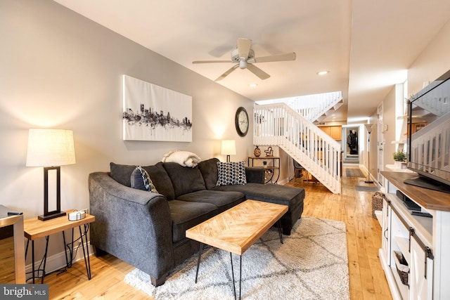 living room with ceiling fan and light hardwood / wood-style floors