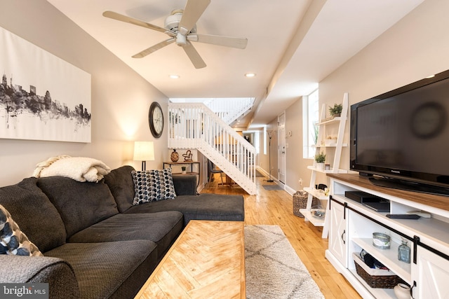 living room featuring light hardwood / wood-style floors and ceiling fan