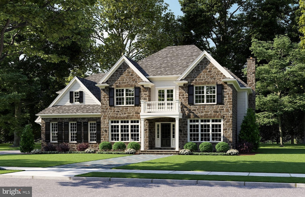 view of front of property with a balcony and a front yard