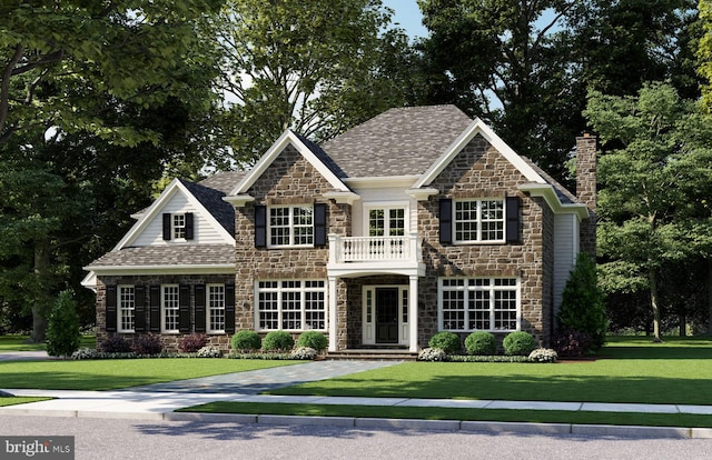 view of front of property with a balcony and a front yard