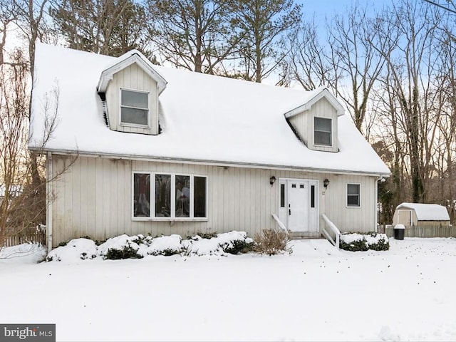 new england style home with a storage shed