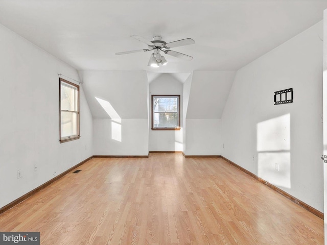 additional living space with ceiling fan, light wood-type flooring, and lofted ceiling