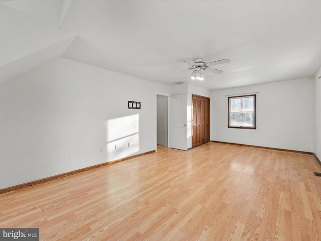 interior space with light hardwood / wood-style flooring, ceiling fan, and lofted ceiling