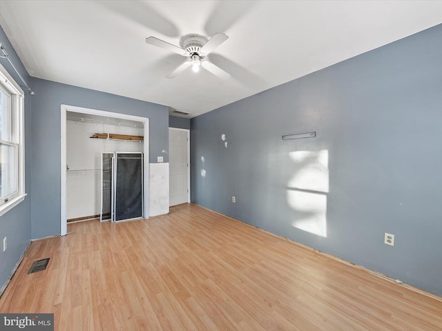 unfurnished living room with ceiling fan and light hardwood / wood-style flooring