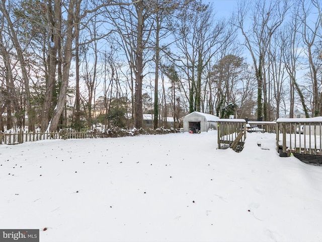 yard layered in snow with an outdoor structure