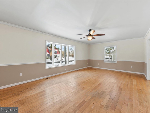 empty room featuring ceiling fan, light wood-type flooring, and ornamental molding