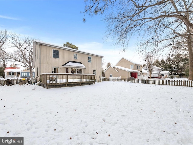 snow covered property with a deck