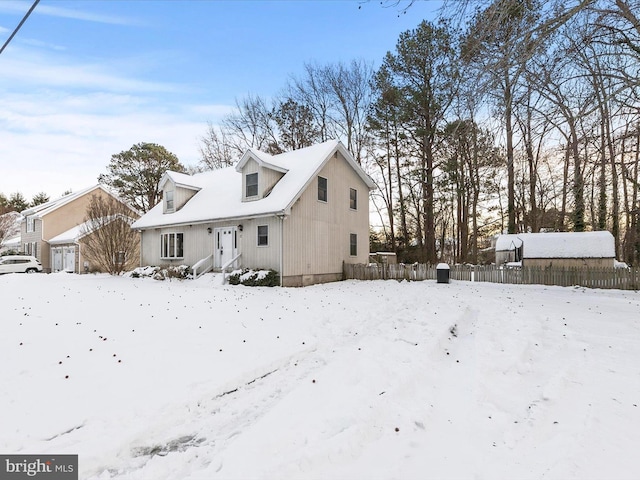 view of snow covered back of property