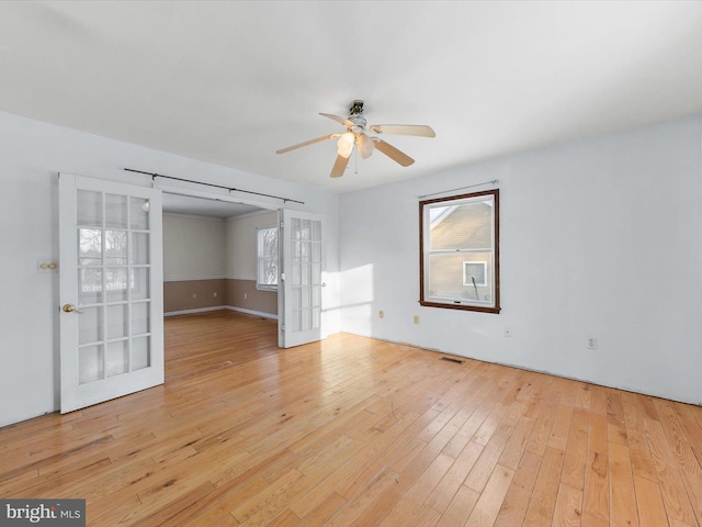 spare room featuring light hardwood / wood-style flooring and ceiling fan