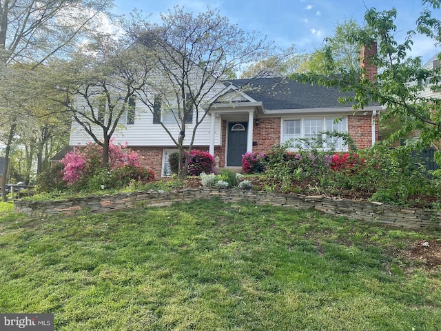 split level home with a front lawn