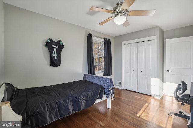 bedroom featuring ceiling fan, a closet, and dark hardwood / wood-style floors