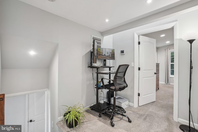 workout room featuring light carpet