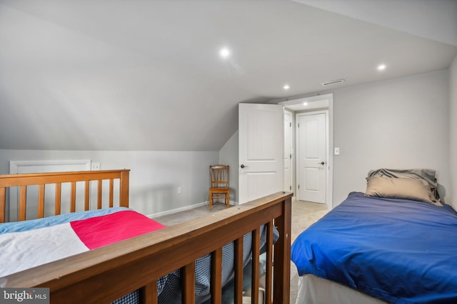 carpeted bedroom with lofted ceiling