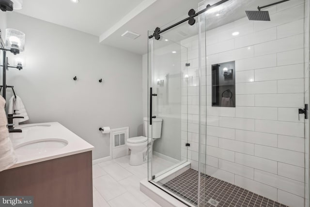 bathroom with tile patterned floors, vanity, toilet, and an enclosed shower