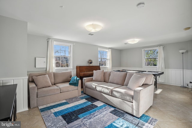 living room with light tile patterned floors and a healthy amount of sunlight