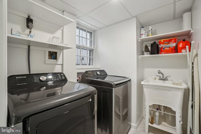 washroom with washing machine and dryer and sink