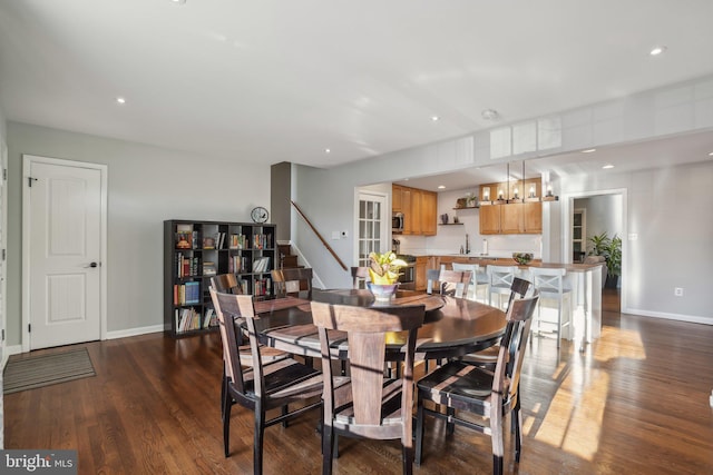 dining room featuring dark hardwood / wood-style flooring and sink