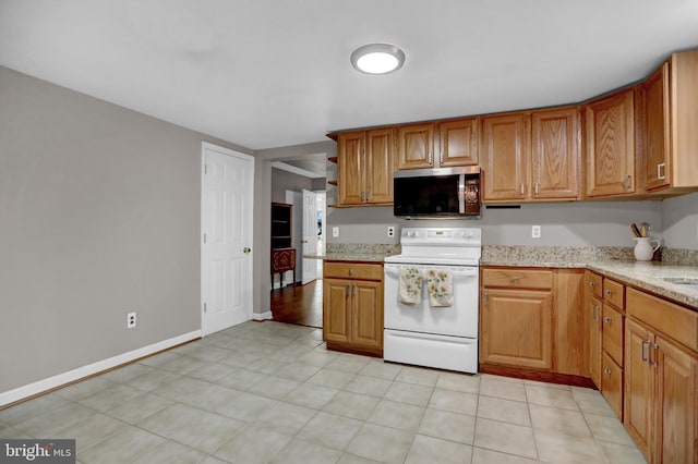 kitchen with light stone counters and white range with electric stovetop