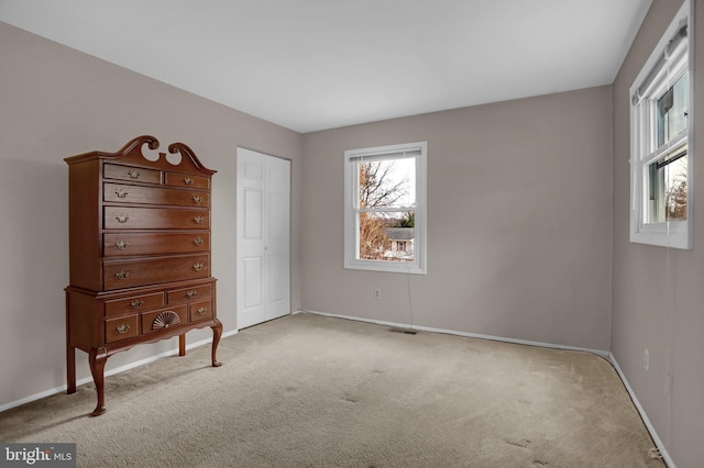 bedroom featuring a closet and light carpet