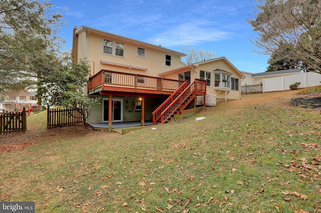 back of house with a wooden deck, a lawn, and a patio area