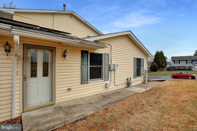 view of home's exterior featuring a patio and a yard