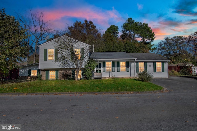 split level home featuring a yard