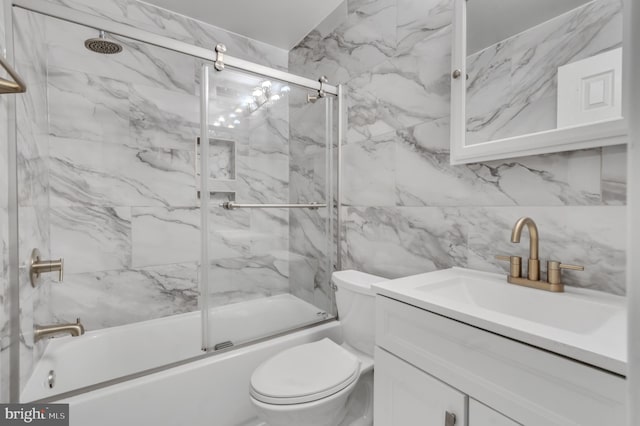 full bathroom with vanity, toilet, and shower / bath combination with glass door