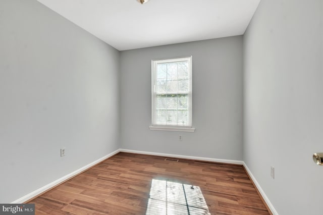 empty room with hardwood / wood-style flooring