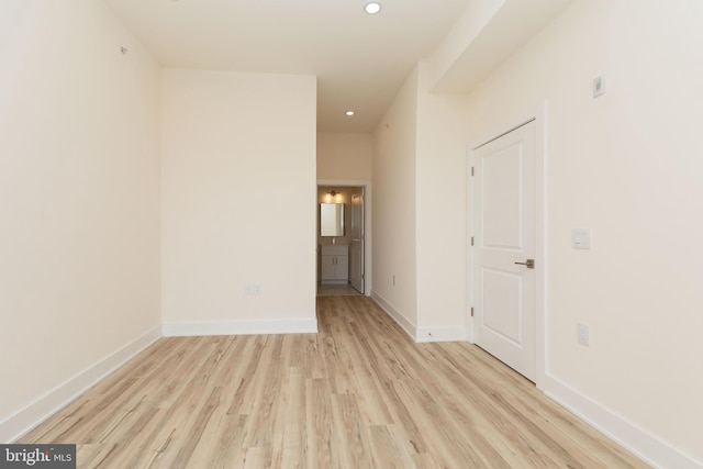 empty room with light hardwood / wood-style flooring