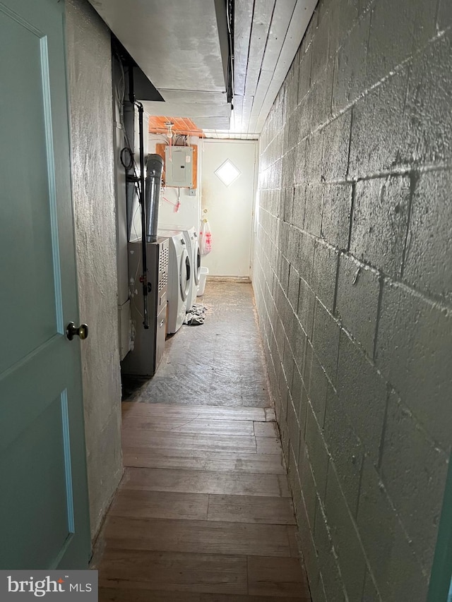 corridor featuring electric panel, hardwood / wood-style flooring, and washer and clothes dryer